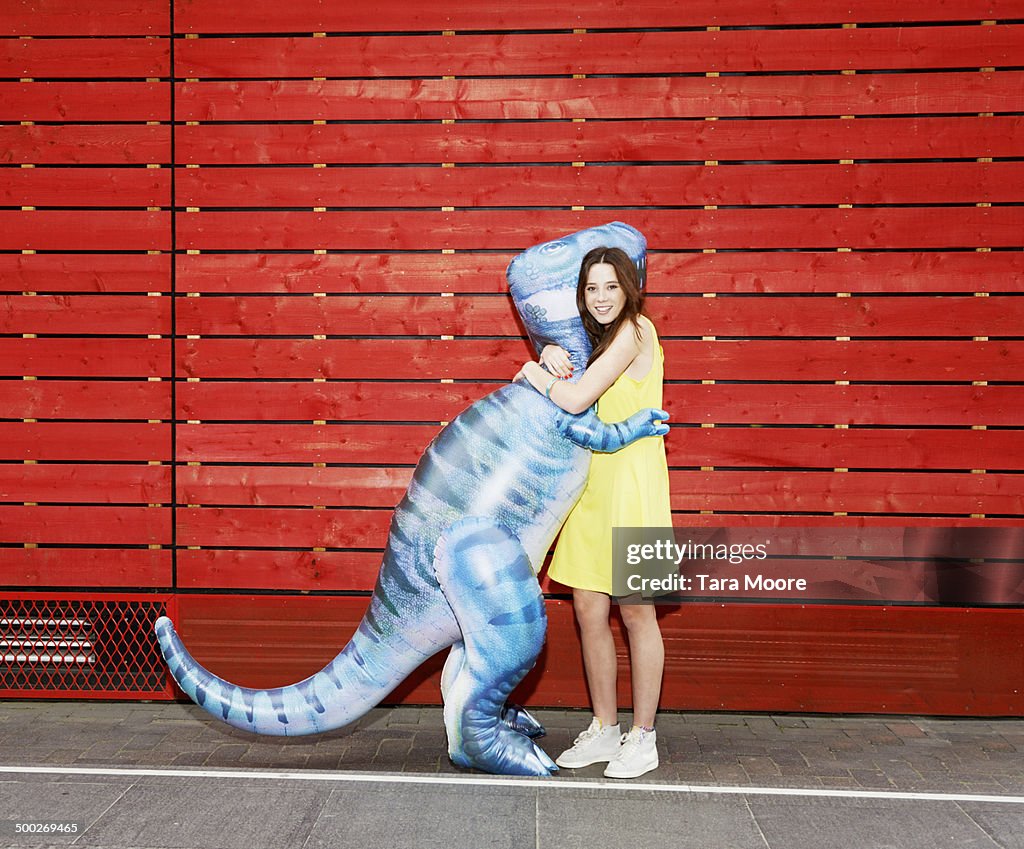 Woman hugging toy dinosaur