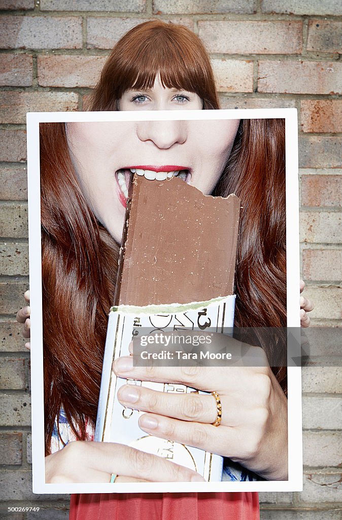 Woman holding picture of chocolate