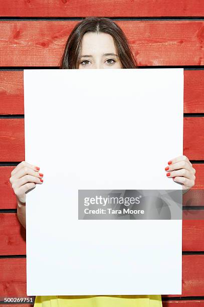 woman holding white message board - women wearing nothing fotografías e imágenes de stock