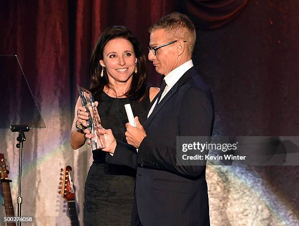 Honoree Michael Lombardo accepts the Trevor Hero award from actress Julia Louis-Dreyfus onstage during TrevorLIVE LA 2015 at Hollywood Palladium on...