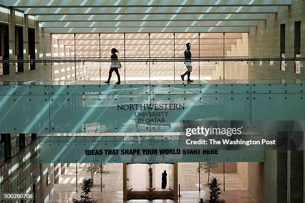 Students cross a sky bridge in the temporary campus of Northwestern University in Qater on the Education City campus in Doha, Qatar, on November 2,...