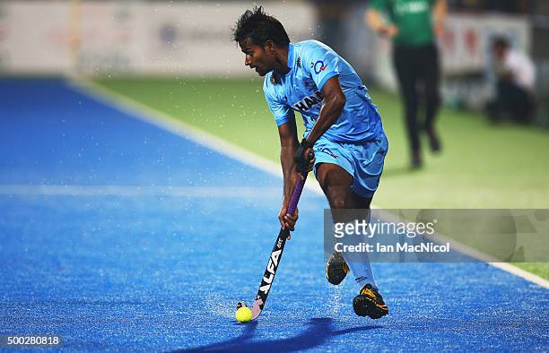 Dharamvir Singh of India runs with the ball during the match between Netherlands and India on day ten of The Hero Hockey League World Final at the...