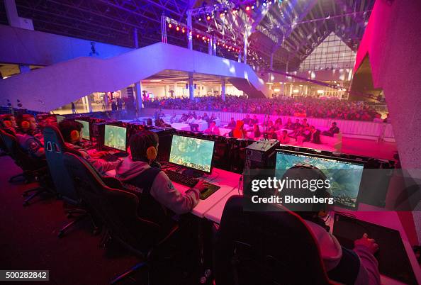 Multiple players compete before an audience in a video game contest ...