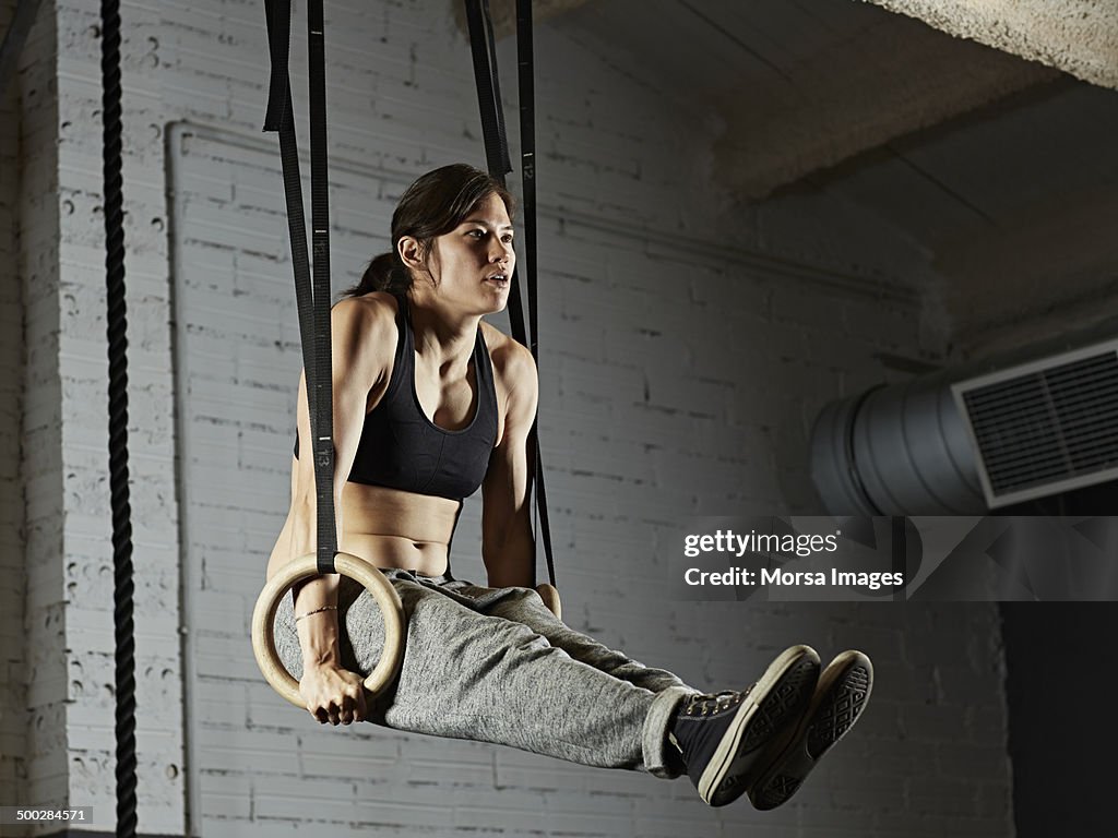 Female gym training with gymnastics rings