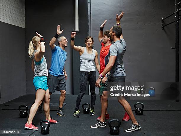group of gymters celebrating workout - five people team stock pictures, royalty-free photos & images