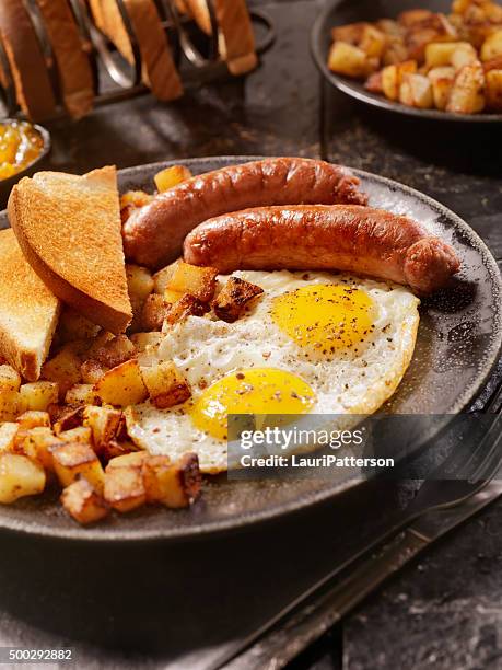 breakfast with sunny side up eggs and sausage - full english breakfast stock pictures, royalty-free photos & images