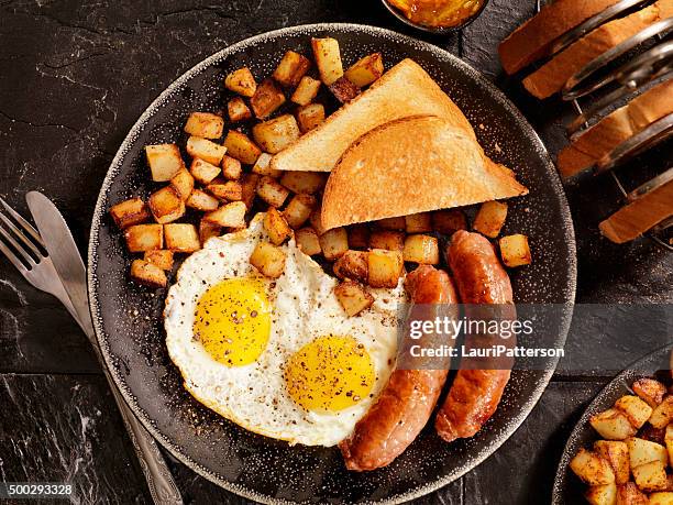 breakfast with sunny side up eggs and sausage - full english breakfast stock pictures, royalty-free photos & images