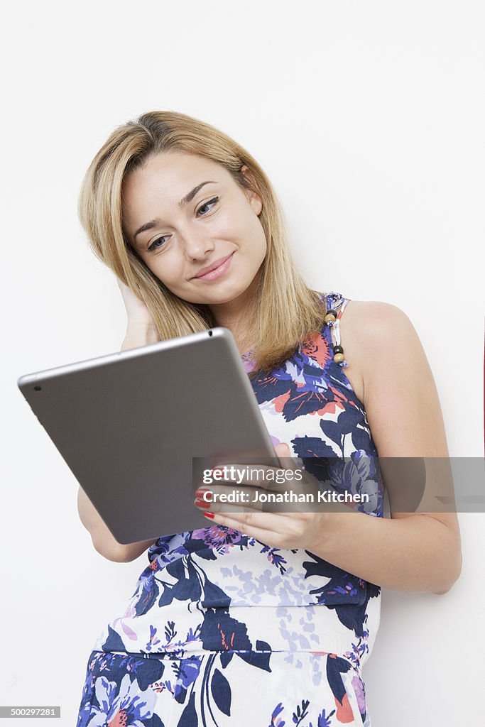 Girl smiles at tablet computer