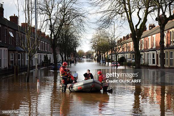 Members of the emergency services prepare to rescue residents from their flooded properties in Carlisle, northern England, on December 7, 2015. Prime...