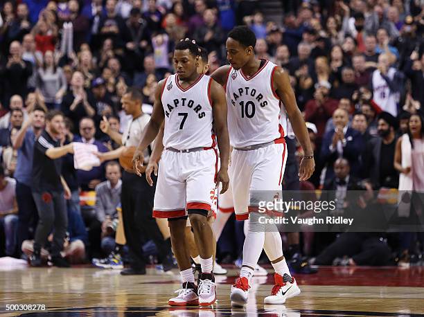 DeMar DeRozan of the Toronto Raptors consoles Kyle Lowry during an NBA game against the Golden State Warriors at the Air Canada Centre on December...