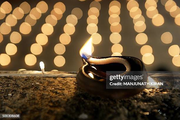 Hindu devotees light oil lamps at a temple for the Hindu God Shiva during the celebration of the Tamil Hindu festival of "Karthigai Deepam" in...