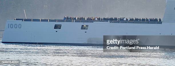 Hundreds of VIPs onboard watch the shoreline as The Zumwalt launches from Bath Ironworks at 8:30 for sea trials and heads down the Kennebec River to...