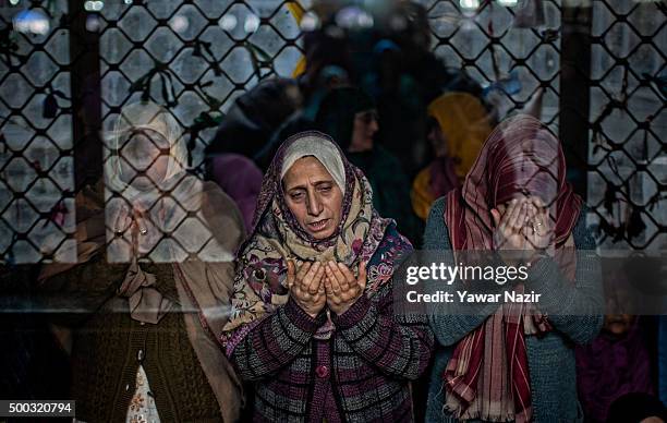 Kashmiri Muslim women devotees pray at the shrine of the Sufi saint Sheikh Hamza Makhdoom during a festival on December 07, 2015 in Srinagar, the...