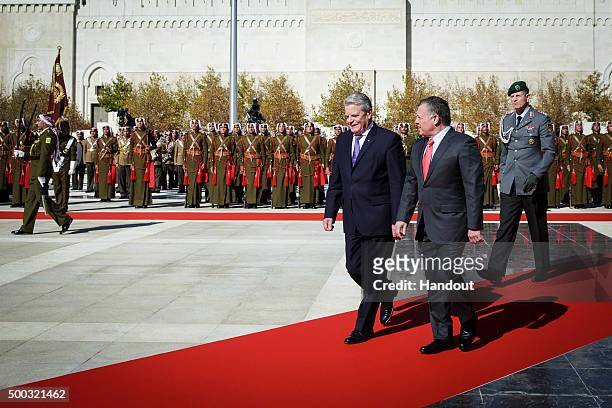 In this handout provided by the German Government Press Office , King Abdullah II of Jordan welcomes President of Germany Joachim Gauck with a...
