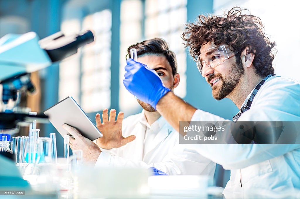 Two scientist using digital tablet in laboratory