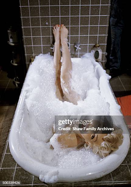 Marilyn Monroe reclines in a bathtub in 1954 during the filming of 'The Seven Year Itch' in Los Angeles, California.