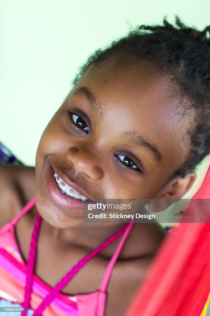 Smiling Black girl with braces diagonal portrait