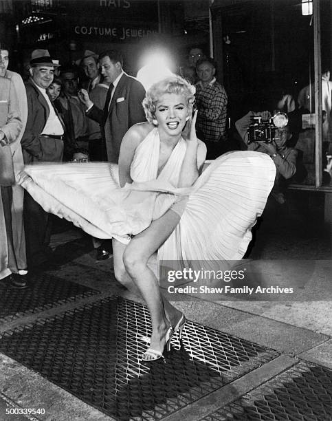 Marilyn Monroe with the skirt of her white dress blowing as she stands over a subway grate at the corner of 51st Street and Lexington Avenue in...