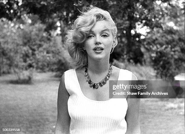 Marilyn Monroe poses with an amber bead necklace in 1957 in Amagansett, New York.