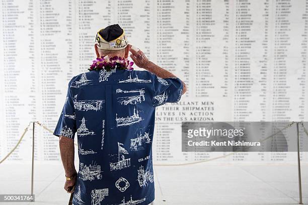 Arizona survivor Lou Conter salutes the Arizona Remembrance Wall during a memorial service marking the 74th Anniversary of the attack on the U.S....