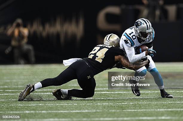 Corey Brown of the Carolina Panthers is brought down by Kyle Wilson of the New Orleans Saints during a game at the Mercedes-Benz Superdome on...