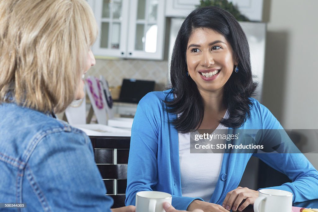 Women having coffee together during home jewelry sales party
