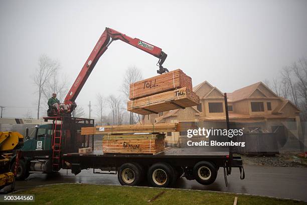 Probuild Holdings Inc. Lumber is unloaded during construction at the Toll Brothers Inc. Enclave at Rye Brook housing development in Rye Brook, New...