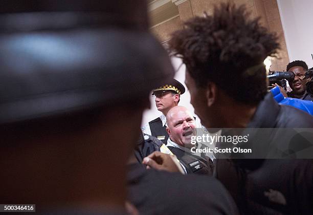 Demonstrators protest the shooting death of Laquan McDonald by a Chicago police officer outside the mayor's office in City Hall on December 7, 2015...