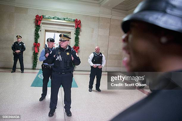 Demonstrators protest the shooting death of Laquan McDonald by a Chicago police officer outside the mayor's office in City Hall on December 7, 2015...