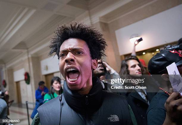 Demonstrators protest the shooting death of Laquan McDonald by a Chicago police officer outside the mayor's office in City Hall on December 7, 2015...