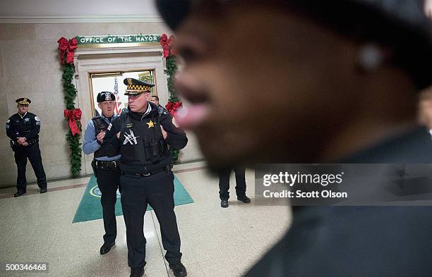 Demonstrators protest the shooting death of Laquan McDonald by a Chicago police officer outside the mayor's office in City Hall on December 7, 2015...