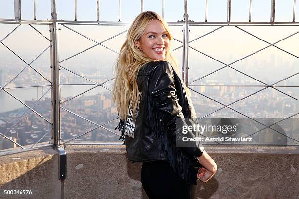 Victoria's Secret Angel Candice Swanepoel lights The Empire State Building In Pink Stripes on December 7, 2015 in New York City.