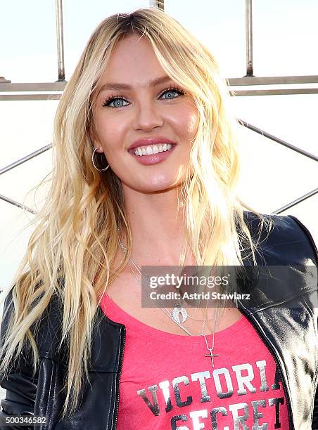 Victoria's Secret Angel Candice Swanepoel lights The Empire State Building In Pink Stripes on December 7, 2015 in New York City.