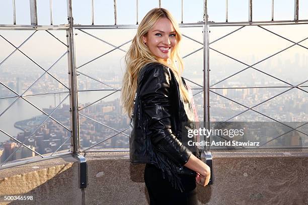 Victoria's Secret Angel Candice Swanepoel lights The Empire State Building In Pink Stripes on December 7, 2015 in New York City.