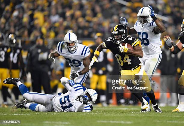 Antonio Brown of the Pittsburgh Steelers carries the ball in front of Mike Adams and Sio Moore of the Indianapolis Colts at Heinz Field on December...