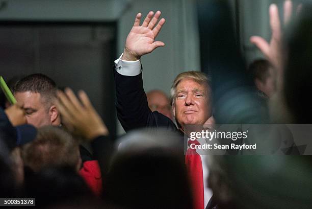 Republican presidential candidate Donald Trump waves to the crowd at a Pearl Harbor Day Rally at the U.S.S. Yorktown December 7, 2015 in Mt....