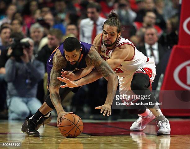 Markieff Morris of the Phoenix Suns and Joakim Noah of the Chicago Bulls battle for a loose ball at the United Center on December 7, 2015 in Chicago,...