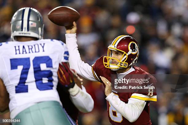 Quarterback Kirk Cousins of the Washington Redskins passes the ball against defensive end Greg Hardy of the Dallas Cowboys in the first quarter at...