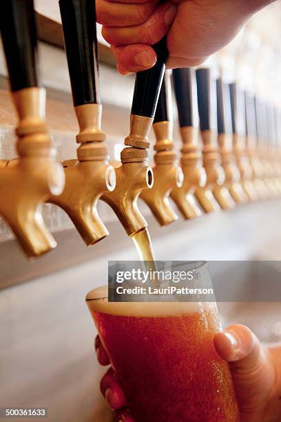 pouring a pint - beer pump stock pictures, royalty-free photos & images