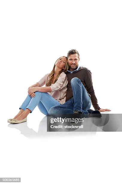 cozy couple sitting on white background - sitting on floor stock pictures, royalty-free photos & images