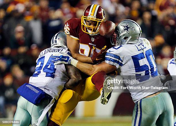 Dallas Cowboys cornerback Morris Claiborne and Dallas Cowboys outside linebacker Sean Lee break up a pass intended for Washington Redskins tight end...