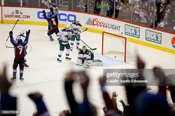 John Mitchell of the Colorado Avalanche celebrates his game-winning goal against goaltender Darcy Kuemper of the Minnesota Wild during overtime at...