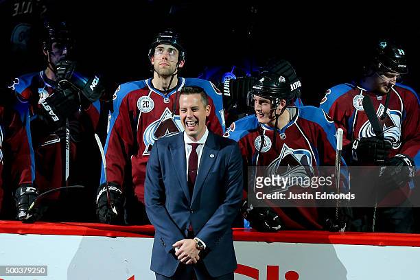 President Josh Kroenke of the Colorado Avalanche laughs on the ice during a ceremony to honor the 20th Anniversary Team before a game against the...