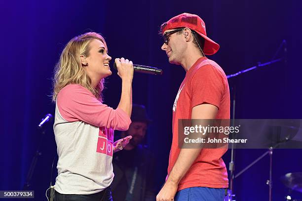 Carrie Underwood and Bobby Bones perform during The Raging Idiots' Million Dollar Show for St. Jude at Ryman Auditorium on December 7, 2015 in...