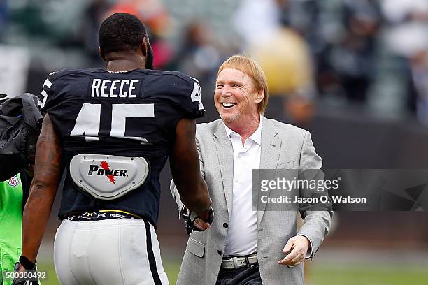 Oakland Raiders owner Mark Davis shakes hands with Marcel Reece on the field before the game against the Kansas City Chiefs at O.co Coliseum on...