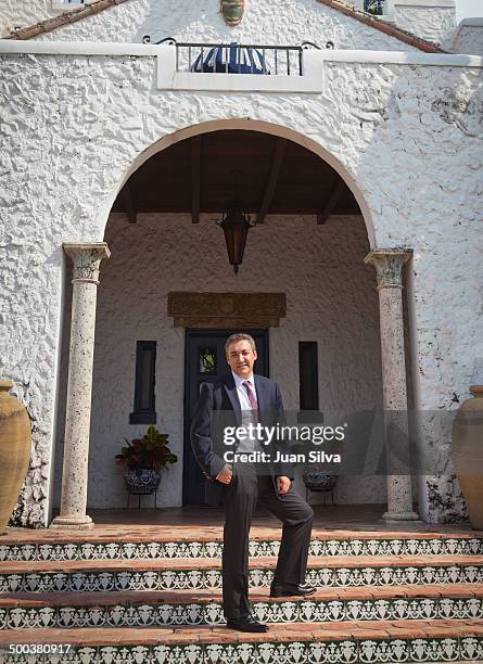 Businessman standing in front of house