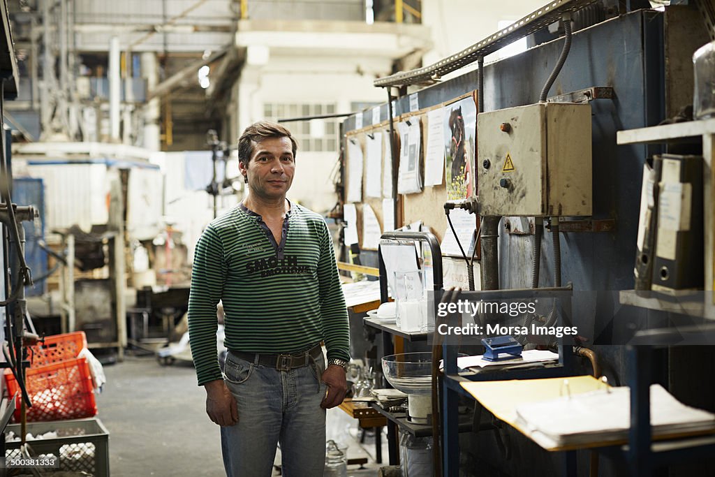 Male glass worker in factory