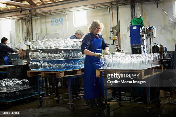 glass worker arranging vases - glass factory stock-fotos und bilder