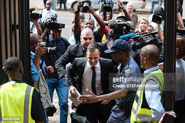 Former Paralympic champion Oscar Pistorius trips as he arrives for his hearing at the South African Gauteng Division High Court in Pretoria, South...
