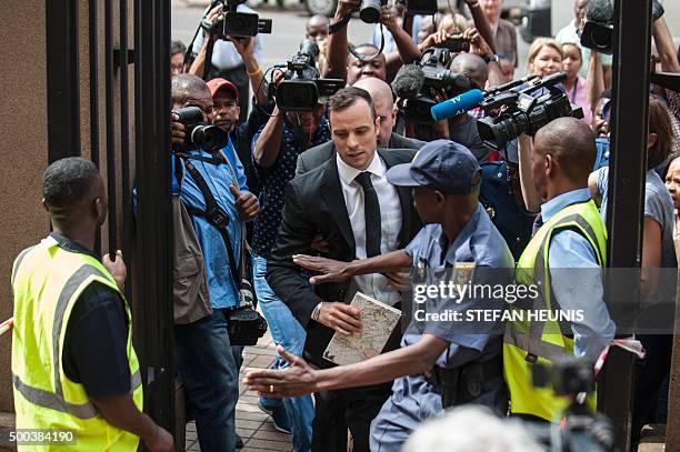 Former Paralympic champion Oscar Pistorius trips as he arrives for his hearing at the South African Gauteng Division High Court in Pretoria, South...